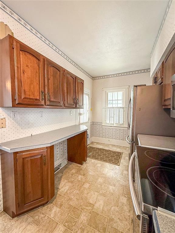 117 Lyon Avenue Butler, PA 16001 - Photo 16 of 43 a kitchen with stainless steel appliances granite countertop a stove a sink and a refrigerator