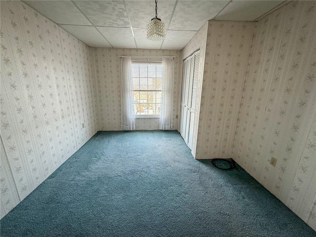 117 Lyon Avenue Butler, PA 16001 - Photo 34 of 43 an empty room with a windows and ceiling fan