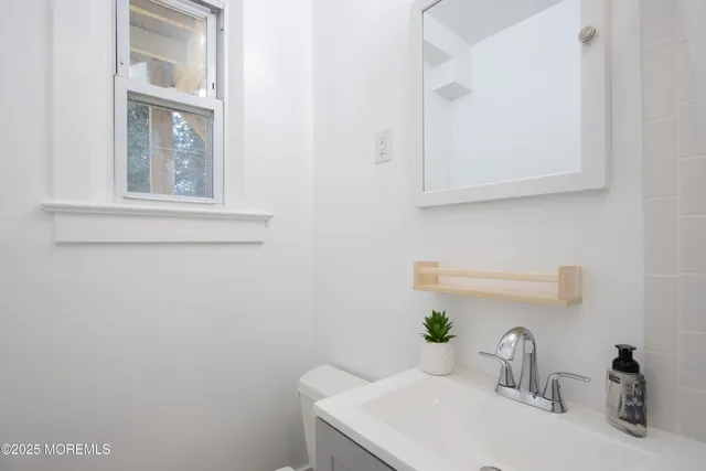 a bathroom with a sink and a window