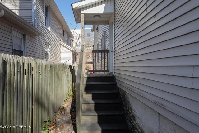 a view of entryway with wooden floor and stairs