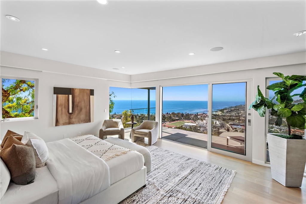 727 Bayview Place Laguna Beach, CA 92651 - Photo 30 of 75 a bedroom with a large bed and a potted plant