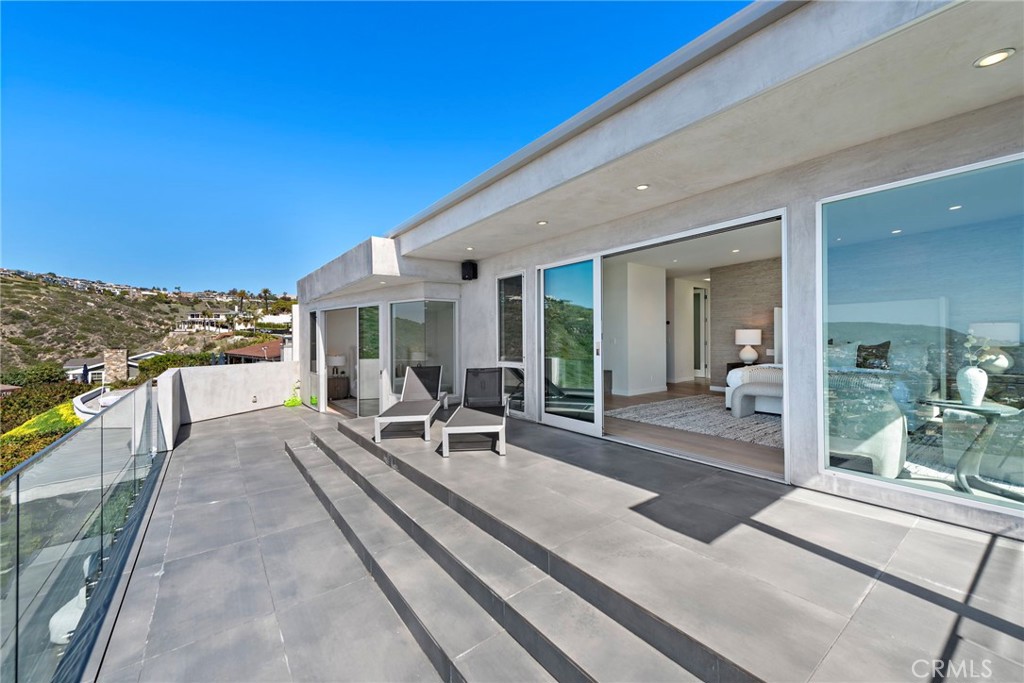 727 Bayview Place Laguna Beach, CA 92651 - Photo 46 of 75 a view of a patio with couches table and chairs with wooden floor and fence