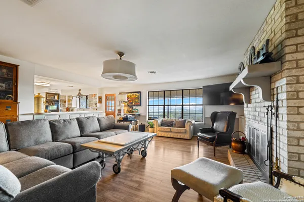 a living room with furniture fireplace and a large window
