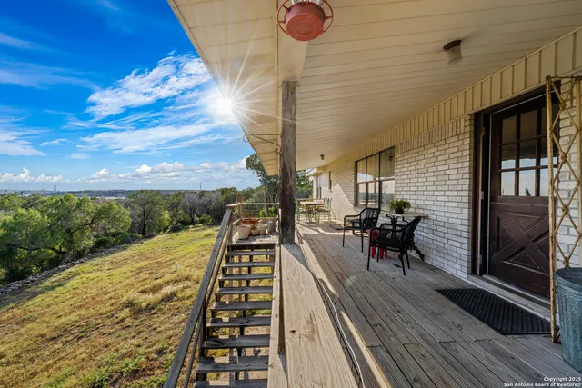 a view of balcony with wooden floor and seating space