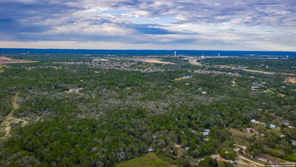 an aerial view of residential houses with city view