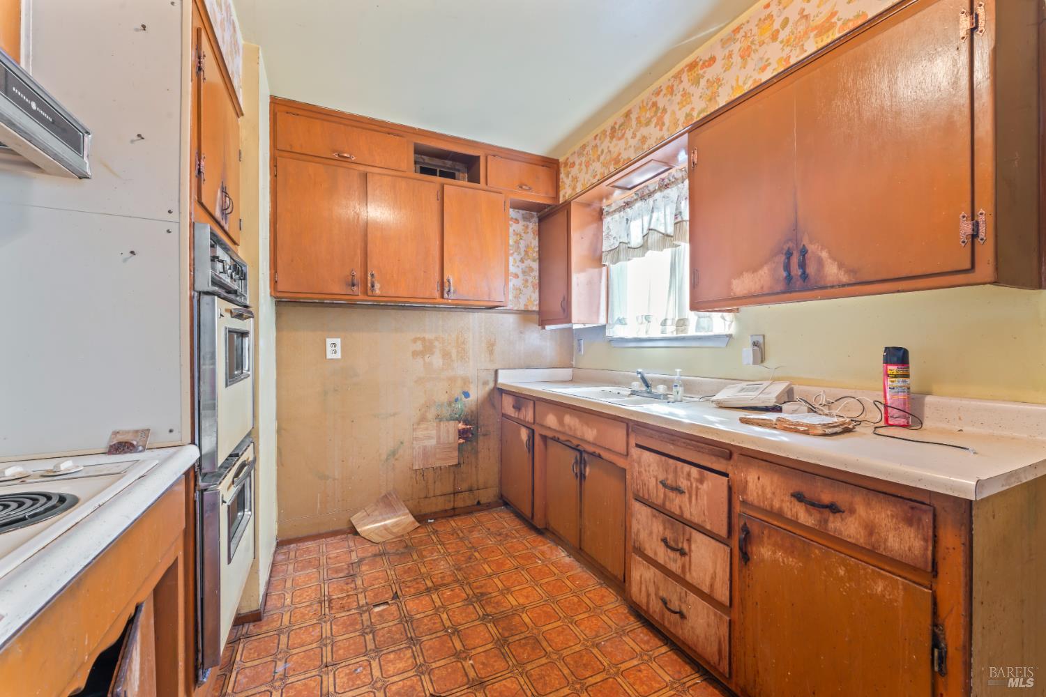 58 Solano Avenue Bay Point, CA 94565 - Photo 13 of 33 a kitchen with a sink stove and cabinets