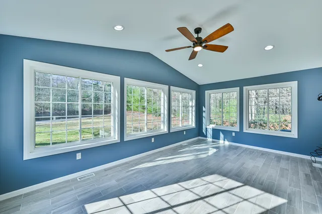 a view of a livingroom with a ceiling fan and a large window
