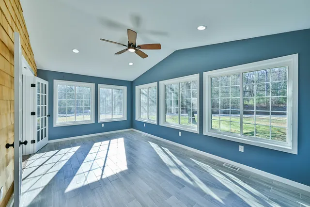 a view of wooden floor and windows in a room