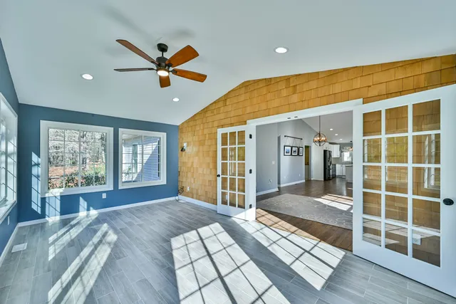 a spacious bedroom with a large bed and a large window