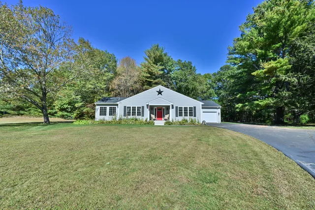 a front view of a house with a garden