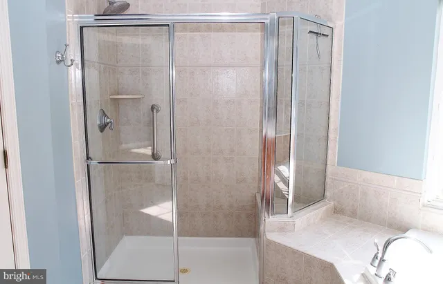 a bathroom with a shower and a sink