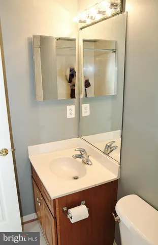a bathroom with a sink vanity and a mirror