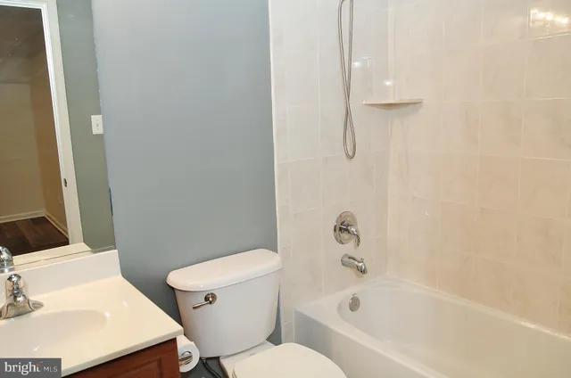 a white bath tub sitting next to a white toilet