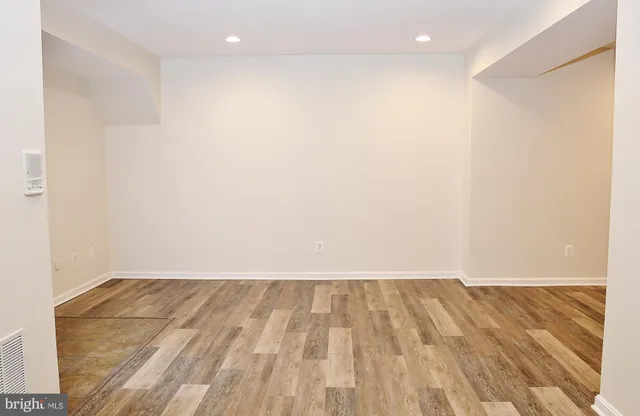 a view of a hallway with wooden floor and entryway
