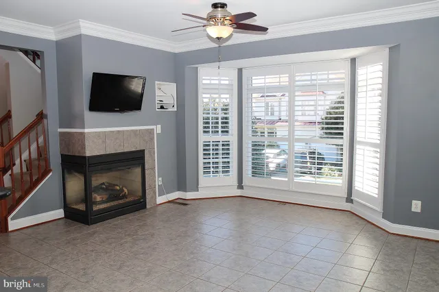 a view of livingroom with furniture fireplace fan and window