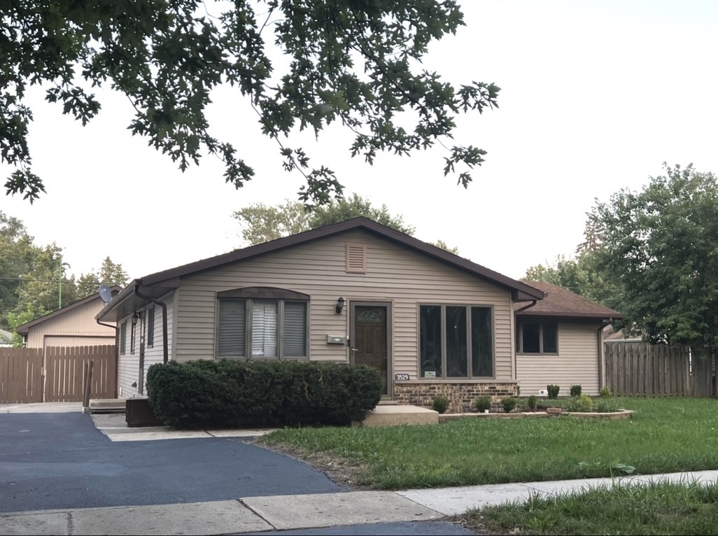 3529 Carpenter Street Steger, IL 60475 - Photo 1 of 20 a front view of a house with a yard and garage
