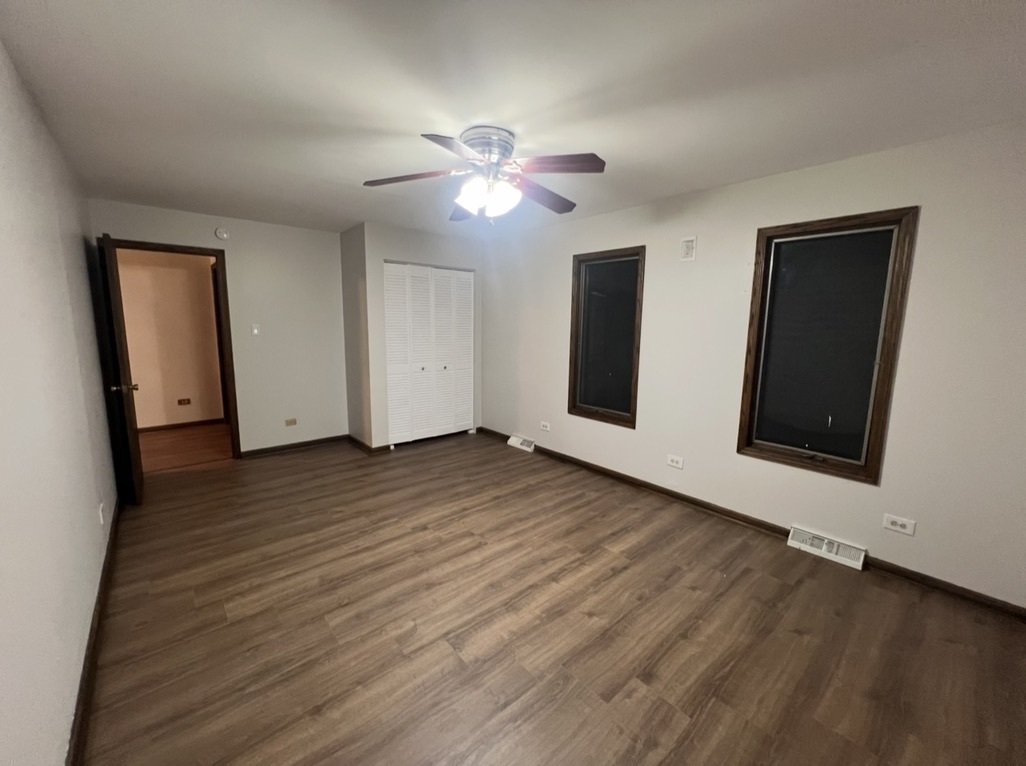 3529 Carpenter Street Steger, IL 60475 - Photo 14 of 20 a view of an empty room with wooden floor and a ceiling fan