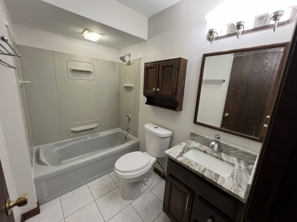 3529 Carpenter Street Steger, IL 60475 - Photo 16 of 20 a bathroom with a granite countertop sink toilet and shower
