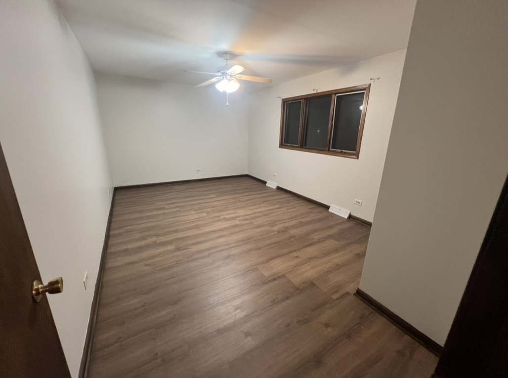 3529 Carpenter Street Steger, IL 60475 - Photo 17 of 20 an empty room with wooden floor and windows