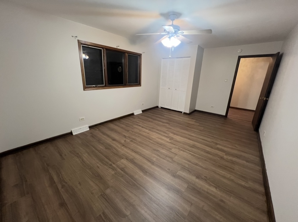 3529 Carpenter Street Steger, IL 60475 - Photo 18 of 20 an empty room with wooden floor and ceiling fan