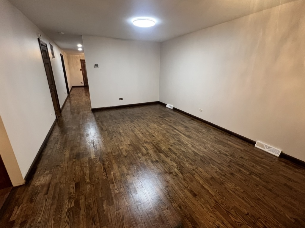 3529 Carpenter Street Steger, IL 60475 - Photo 6 of 20 an empty room with wooden floor and staircase