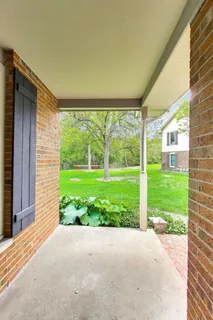 a view of a house with backyard and porch