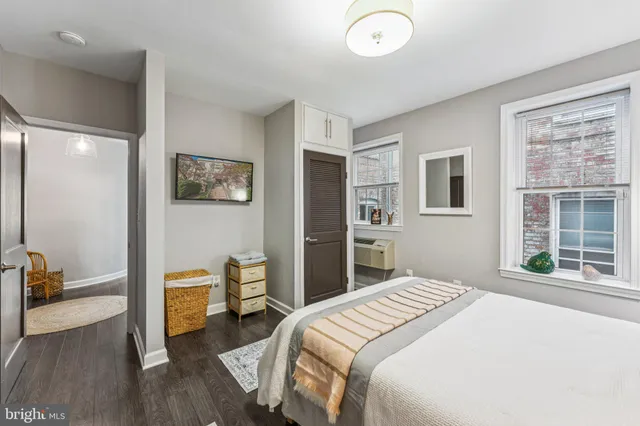 a bedroom with a bed and a large window