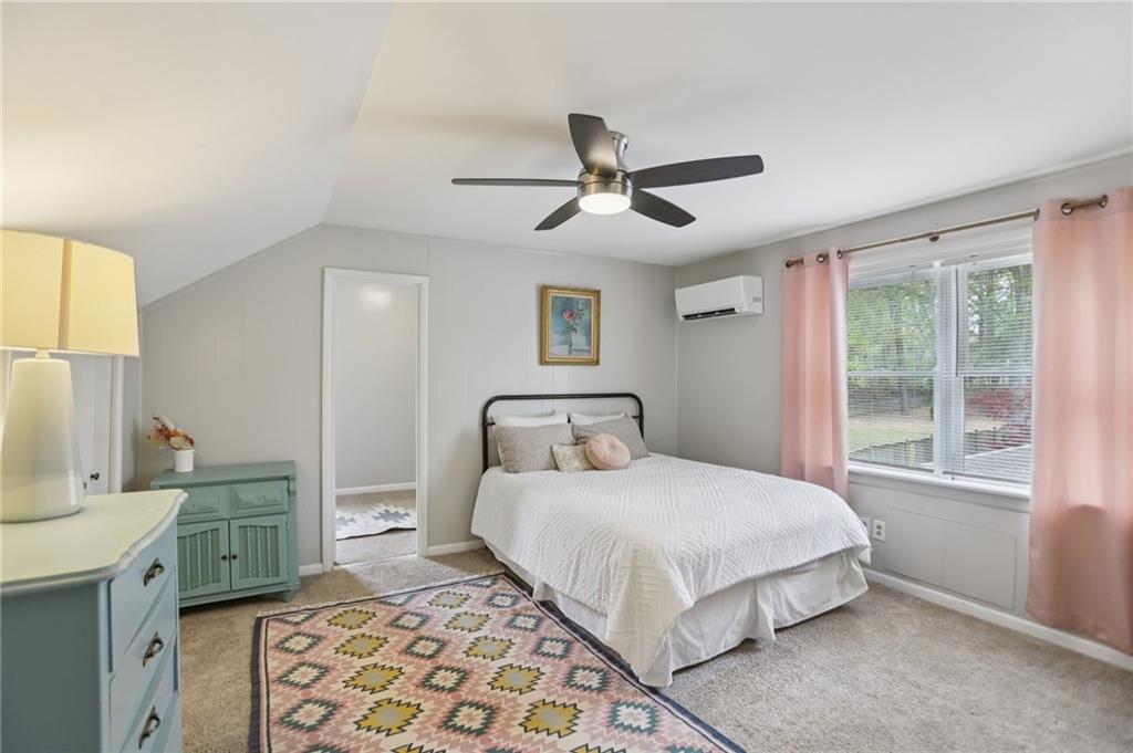 3224 Kensington Road Avondale Estates, GA 30002 - Photo 30 of 59 a bedroom with a bed and a chandelier