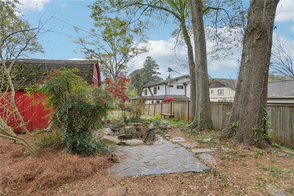 3224 Kensington Road Avondale Estates, GA 30002 - Photo 43 of 59 a view of a brick house with large trees next to a road