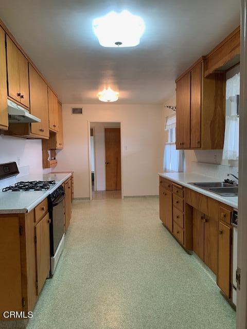 1561 Little Farms Road Oxnard, CA 93030 - Photo 17 of 37 a large kitchen with stainless steel appliances granite countertop a stove a sink and a refrigerator