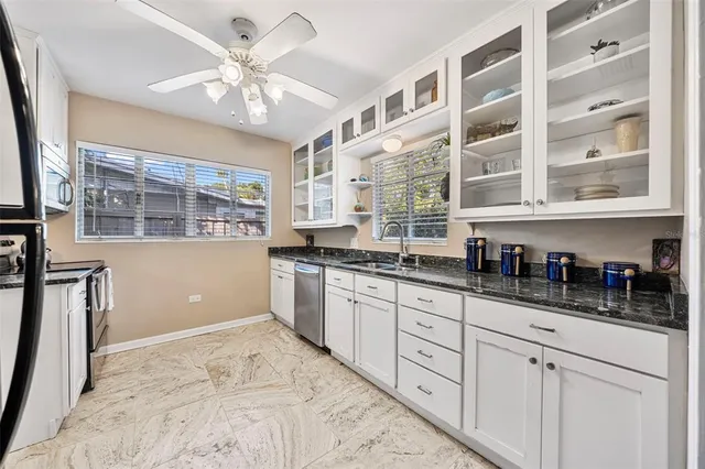 a spacious bedroom with a bed a couch and a window