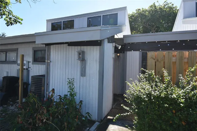 a view of a house with potted plants