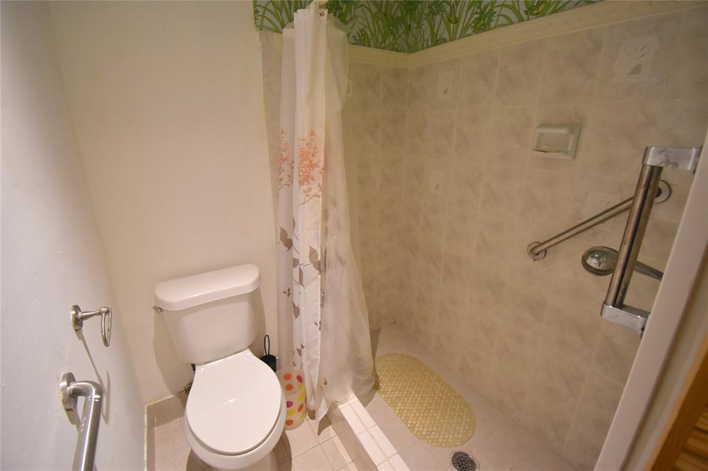 1713 Northwest 73rd Avenue, Unit 34 Plantation, FL 33313 - Photo 13 of 26 a white toilet sitting next to a shower