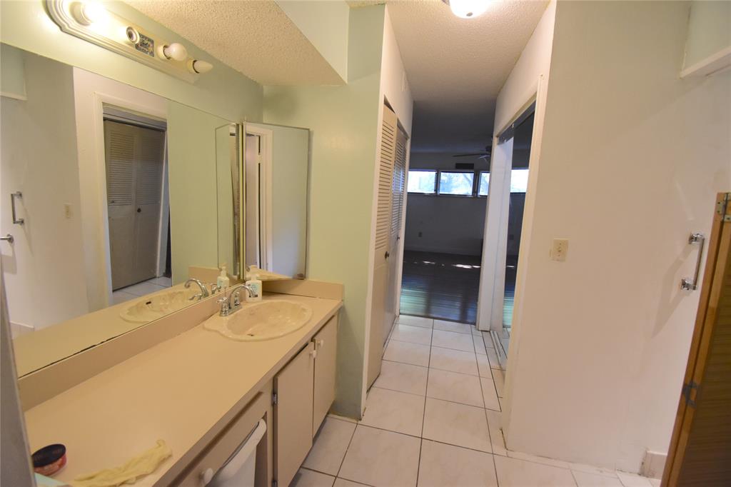 1713 Northwest 73rd Avenue, Unit 34 Plantation, FL 33313 - Photo 17 of 26 a bathroom with a sink and a mirror