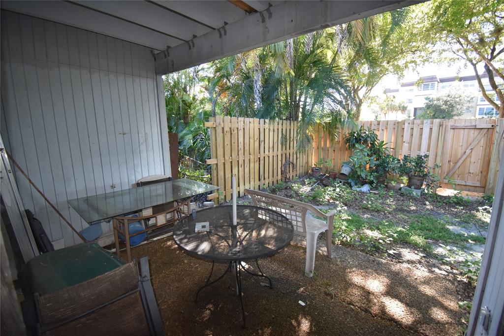 1713 Northwest 73rd Avenue, Unit 34 Plantation, FL 33313 - Photo 18 of 26 a view of backyard with a patio and outdoor seating