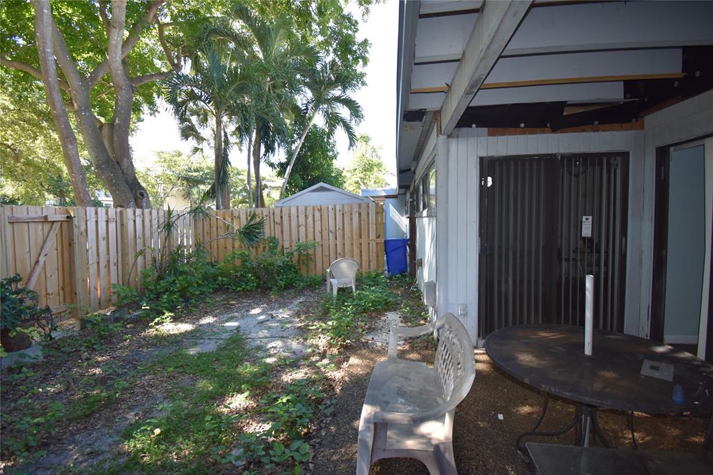 1713 Northwest 73rd Avenue, Unit 34 Plantation, FL 33313 - Photo 19 of 26 a view of a backyard with plants and large trees