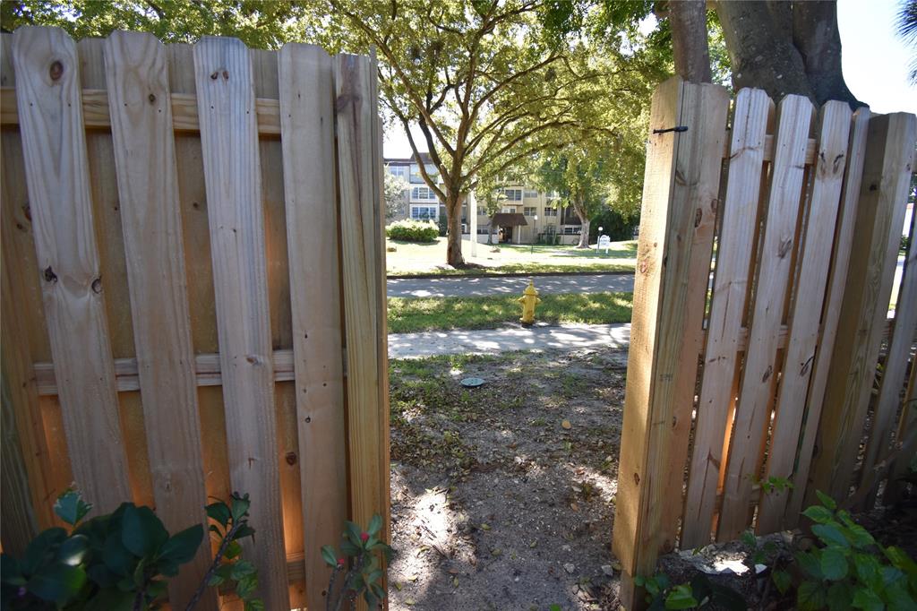 1713 Northwest 73rd Avenue, Unit 34 Plantation, FL 33313 - Photo 24 of 26 a view of a house with a yard