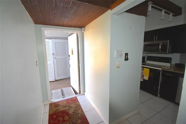 a view of a hallway to rooms and stairs