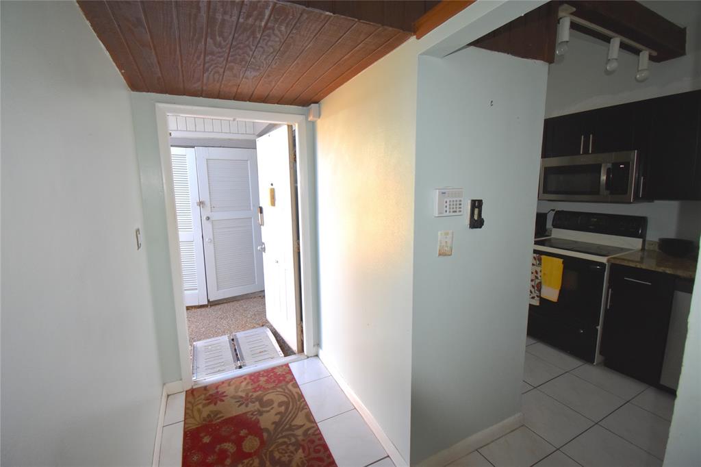 1713 Northwest 73rd Avenue, Unit 34 Plantation, FL 33313 - Photo 3 of 26 a view of a hallway to rooms and stairs