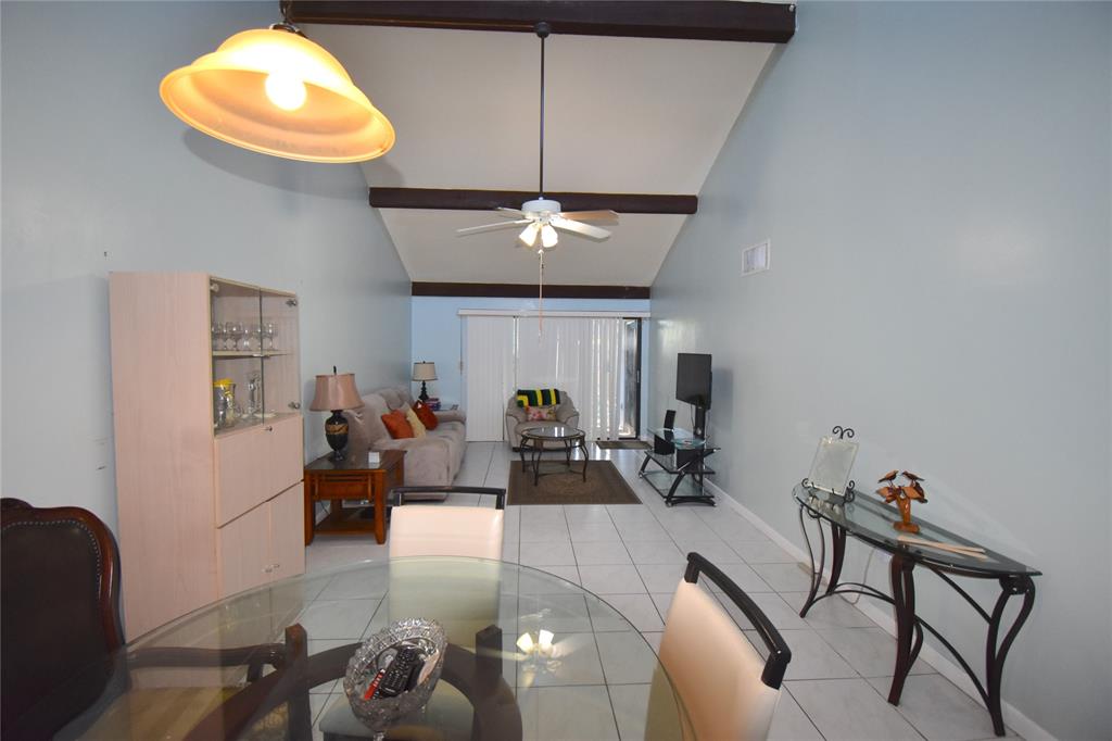 1713 Northwest 73rd Avenue, Unit 34 Plantation, FL 33313 - Photo 6 of 26 a living room with furniture a chandelier and a window