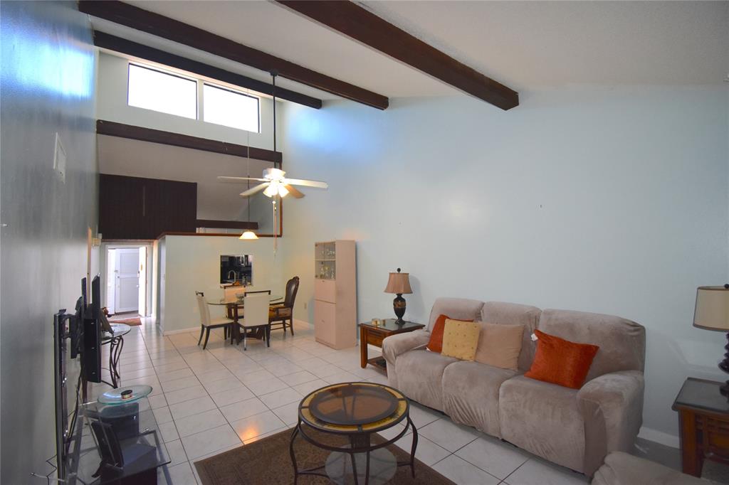 1713 Northwest 73rd Avenue, Unit 34 Plantation, FL 33313 - Photo 7 of 26 a living room with furniture and a chandelier