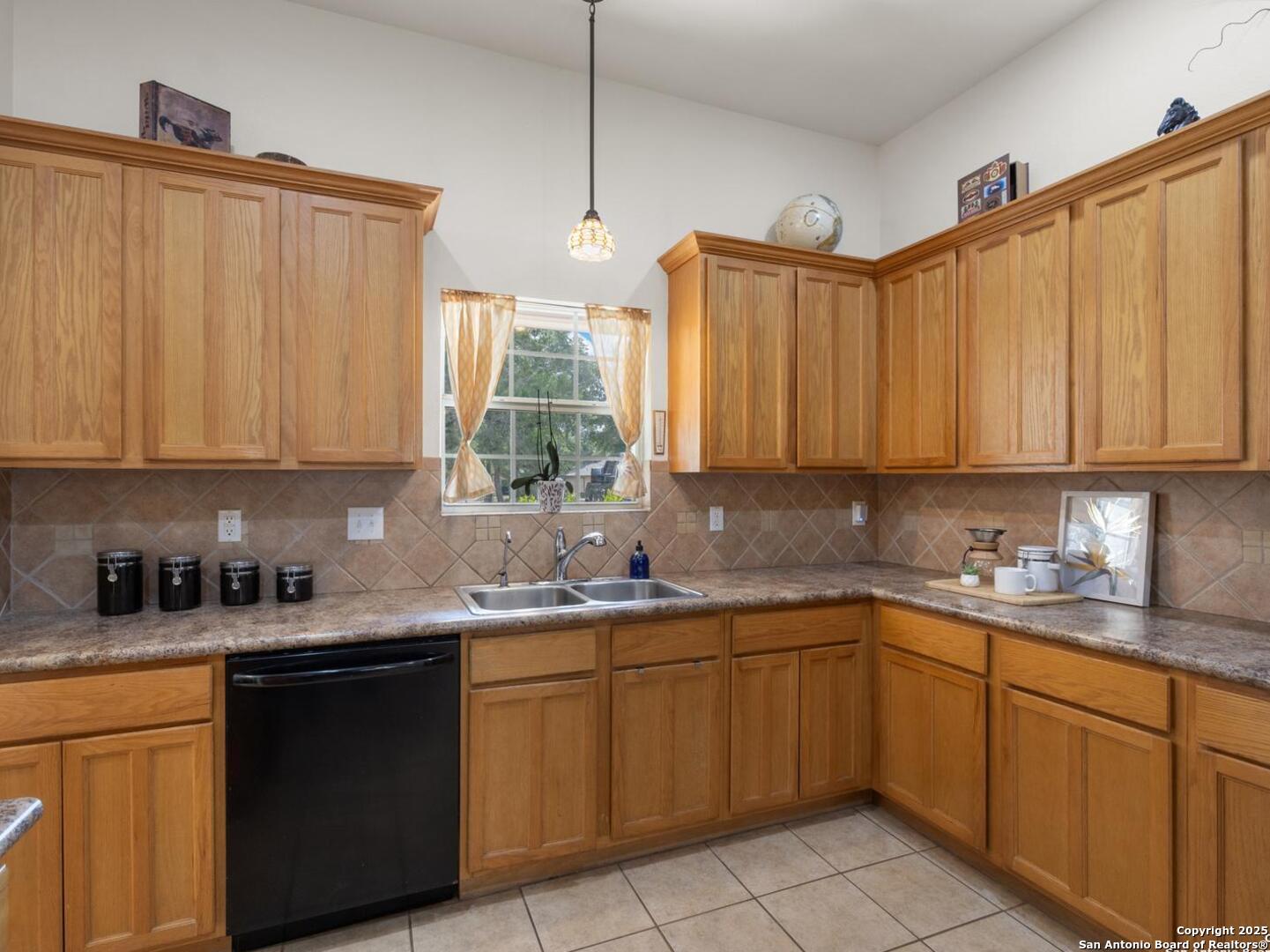 604 Guadalupe Drive Spring Branch, TX 78070 - Photo 11 of 41 a kitchen with stainless steel appliances granite countertop a sink a stove a refrigerator with white cabinets and wooden floor