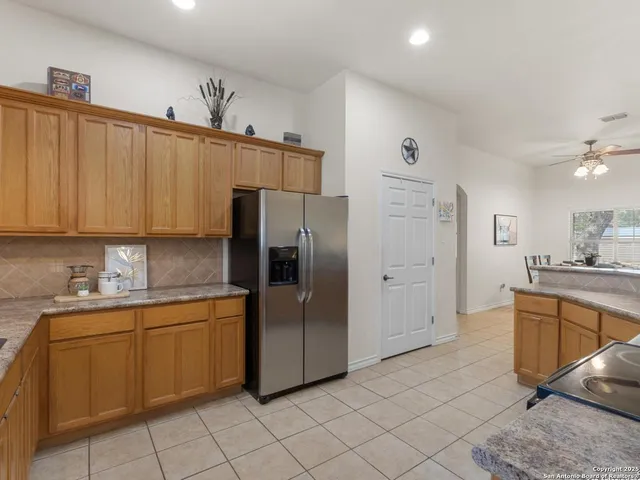 a kitchen with stainless steel appliances a refrigerator sink and cabinets