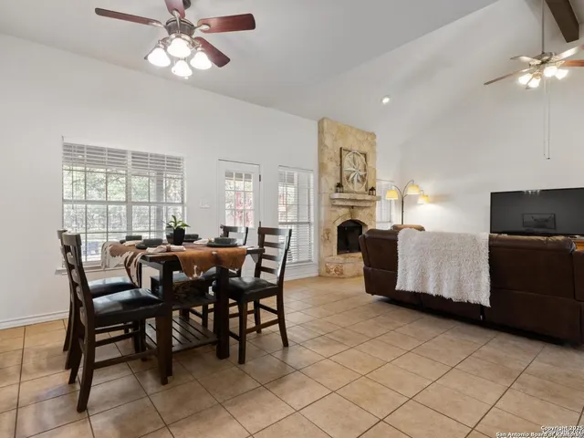 a view of a dining room with furniture and chandelier