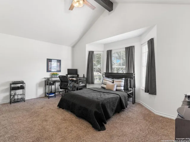 a bedroom with a bed couch and a window