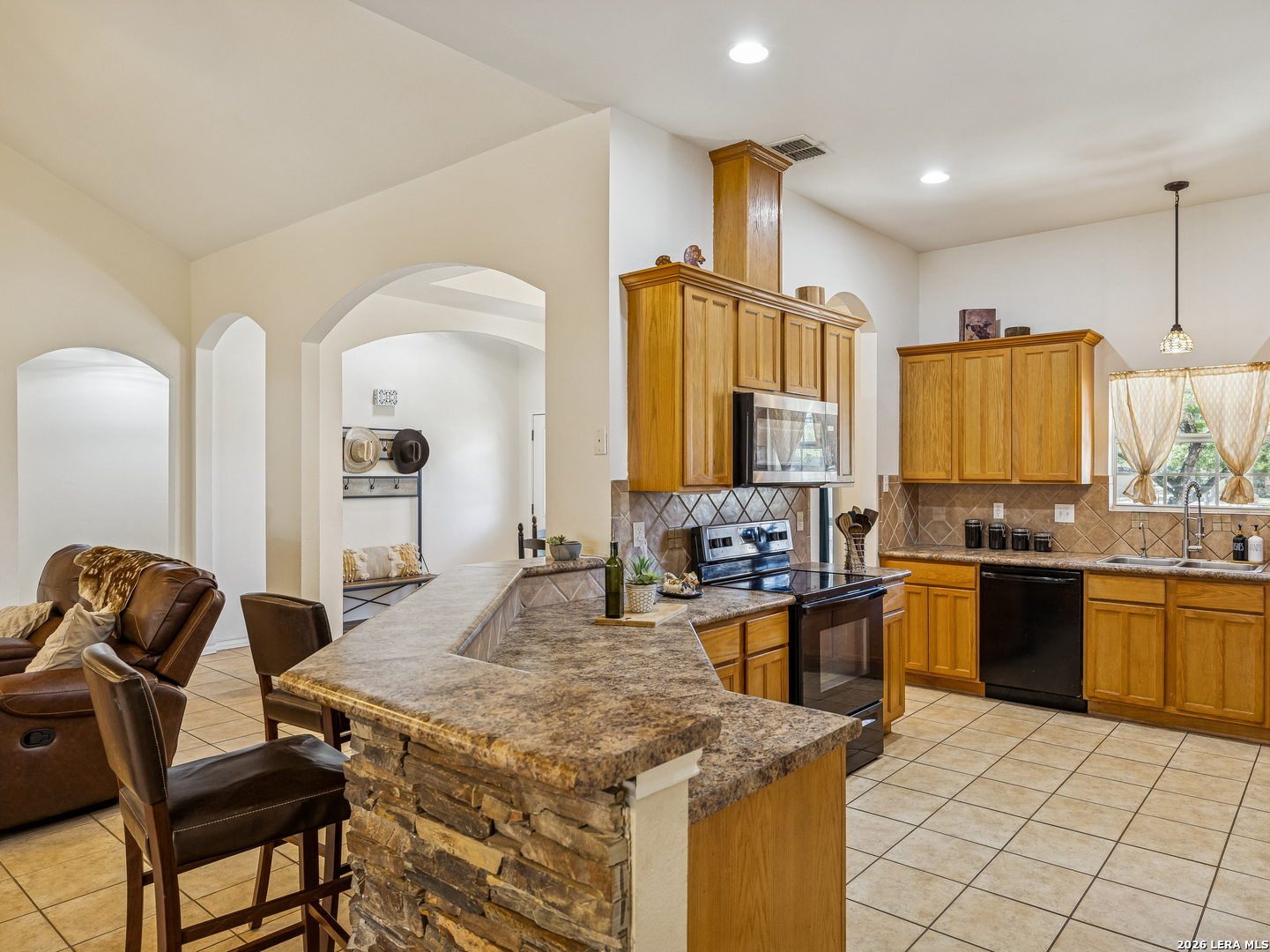 604 Guadalupe Drive Spring Branch, TX 78070 - Photo 18 of 54 a kitchen with stainless steel appliances granite countertop a stove top oven a sink a dining table and chairs