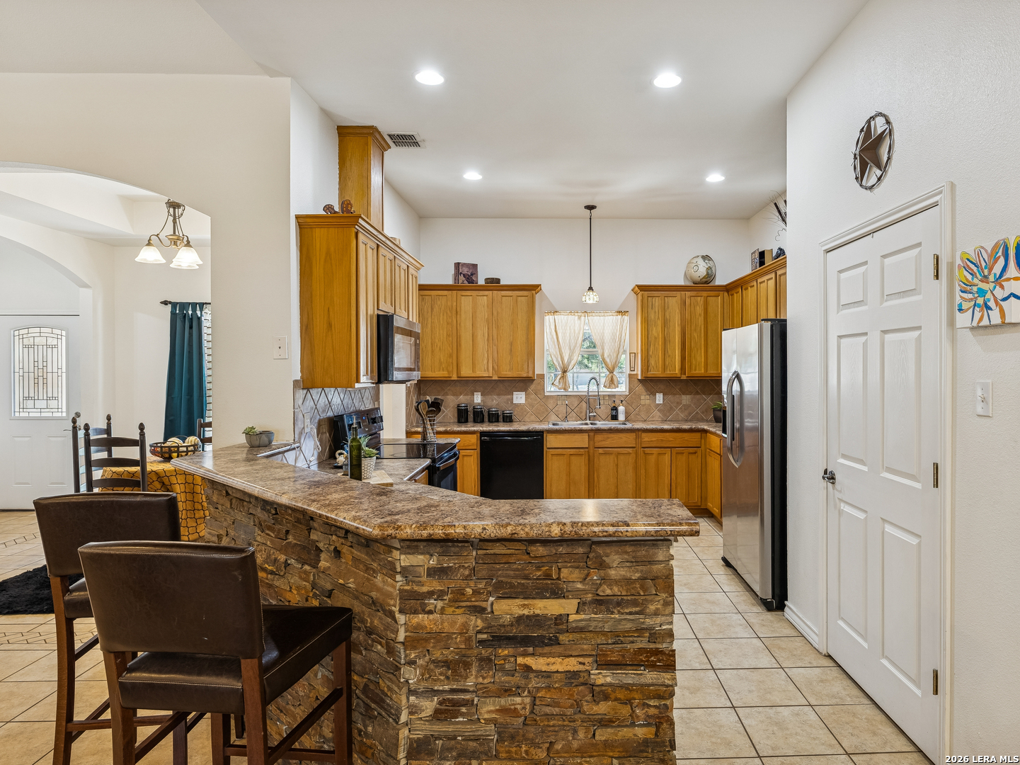604 Guadalupe Drive Spring Branch, TX 78070 - Photo 19 of 54 a kitchen with stainless steel appliances kitchen island granite countertop a refrigerator and a stove top oven