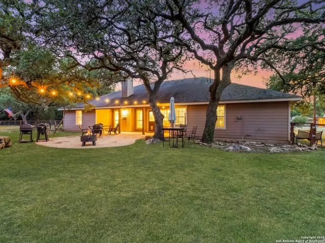 a view of a backyard with large trees
