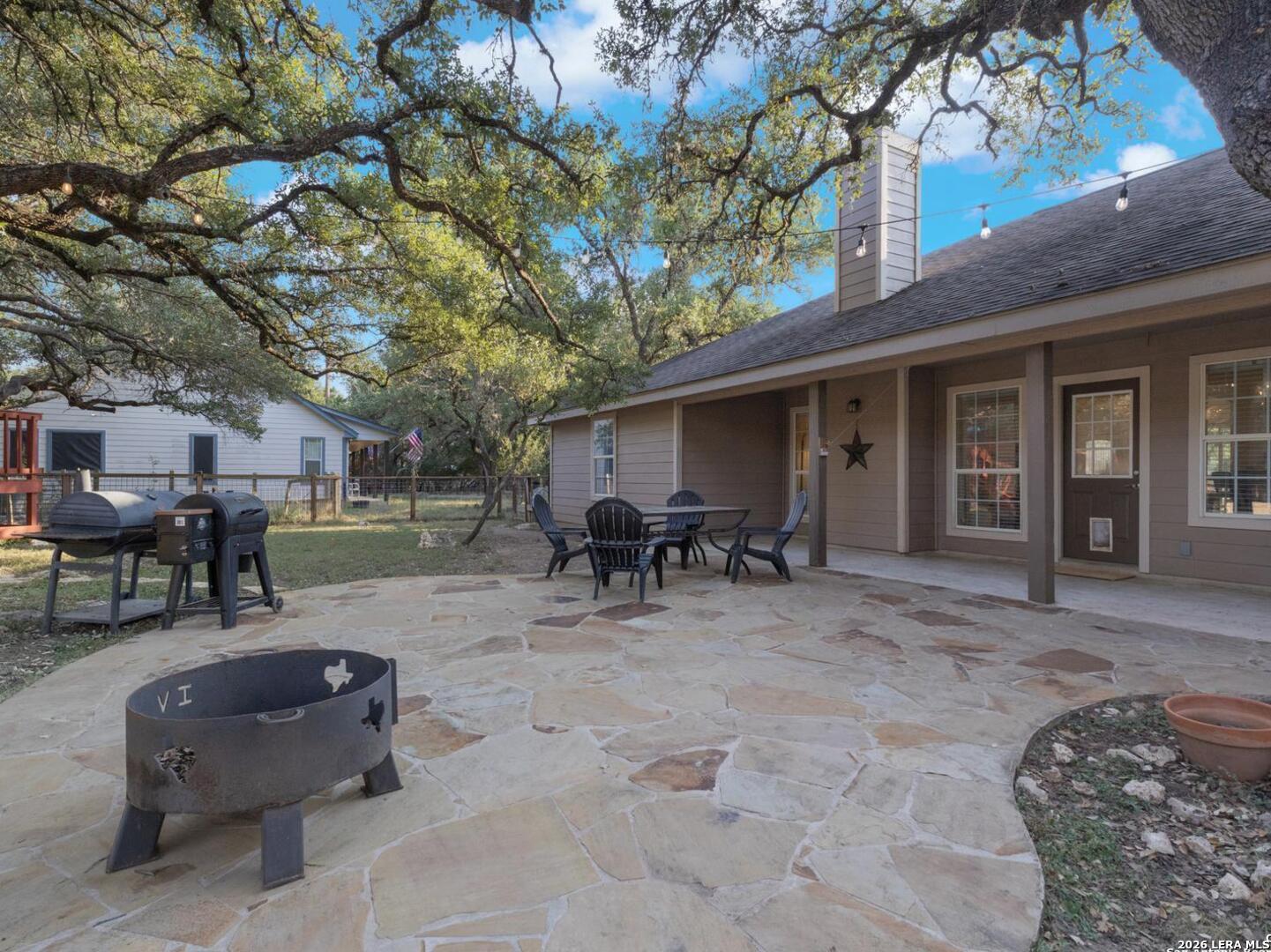 604 Guadalupe Drive Spring Branch, TX 78070 - Photo 37 of 54 a view of a backyard with table and chairs and a large tree