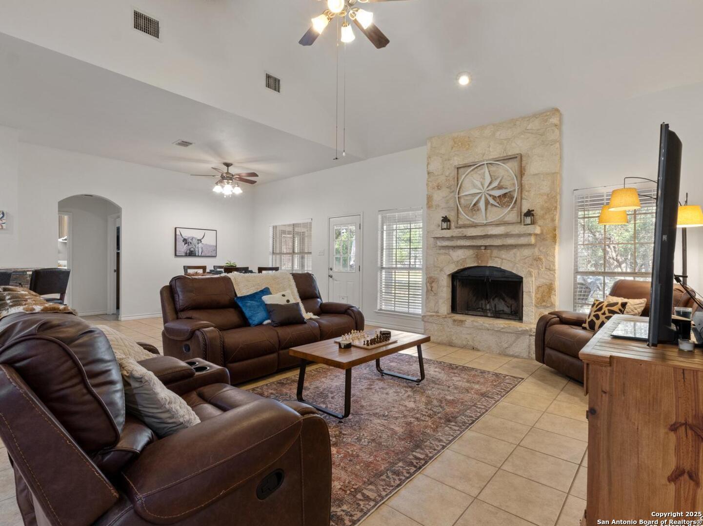 604 Guadalupe Drive Spring Branch, TX 78070 - Photo 7 of 41 a living room with furniture a fireplace and a floor to ceiling window